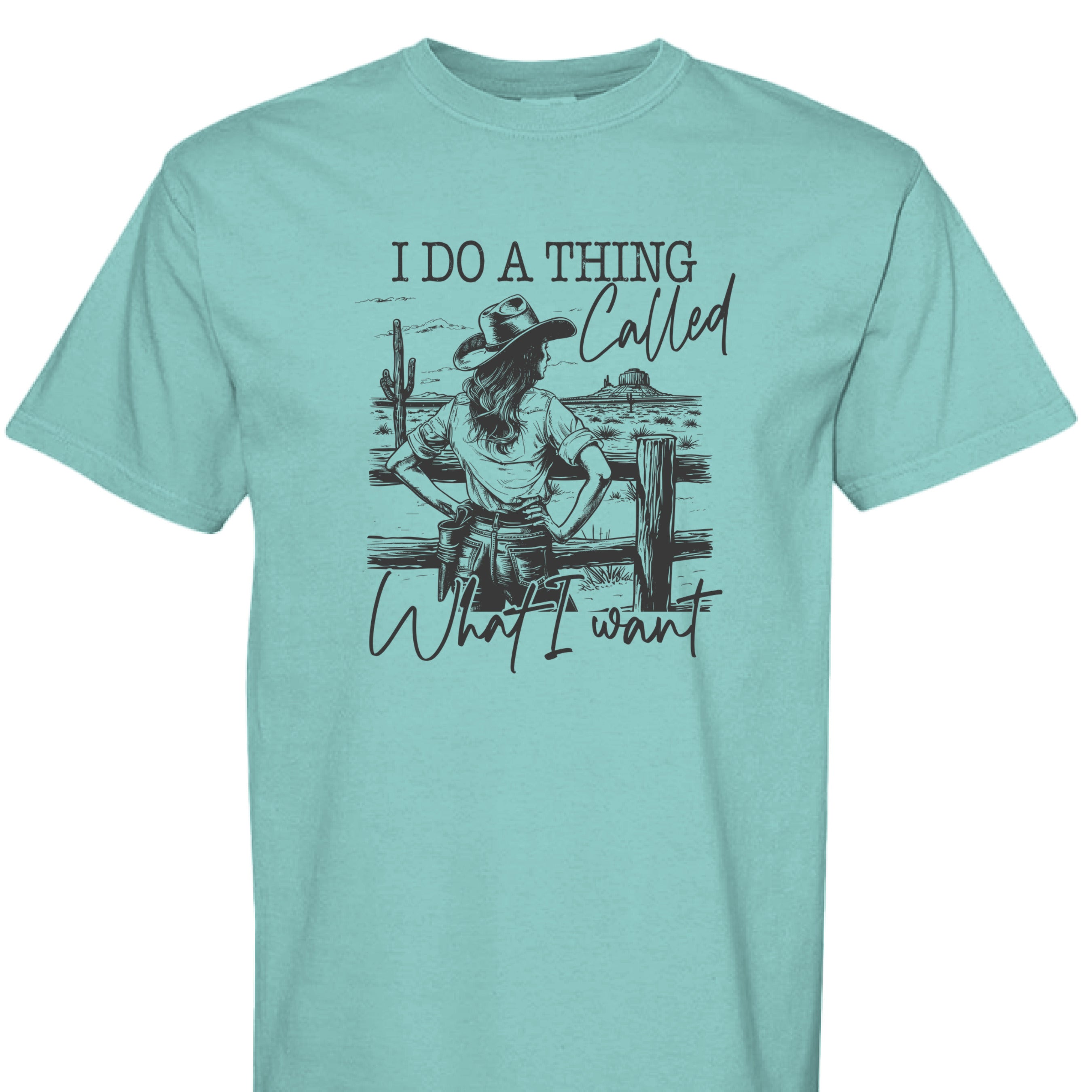CHALKY MINT - FRONT - I Do a Thing Called What I Want western shirt with cowgirl in hat and boots leaning on fence in desert landscape.