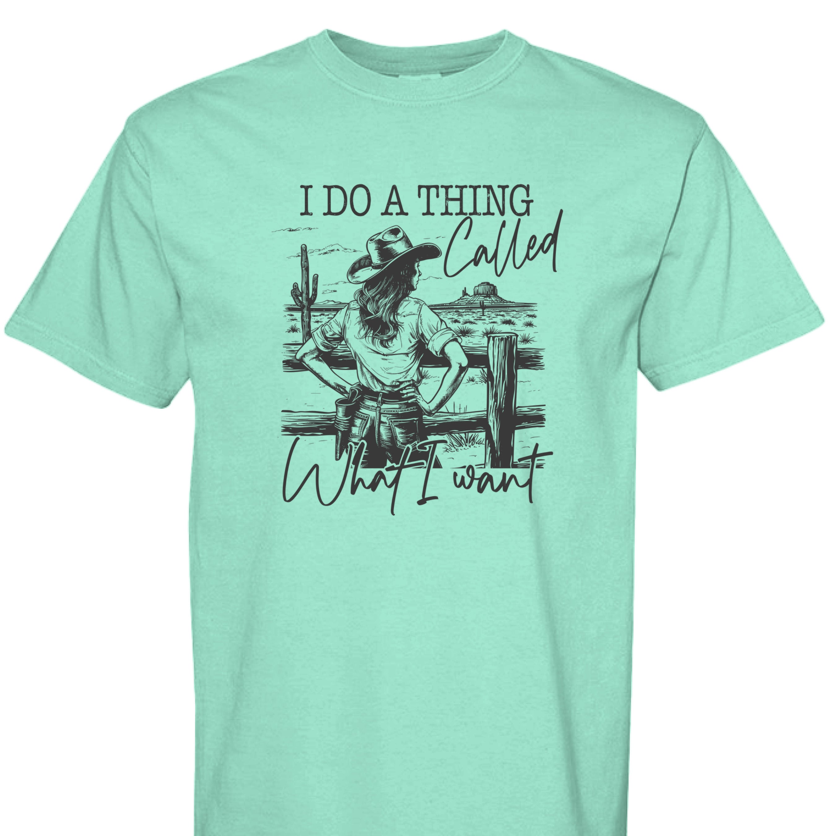 ISLAND REEF - FRONT - I Do a Thing Called What I Want western shirt with cowgirl in hat and boots leaning on fence in desert landscape.