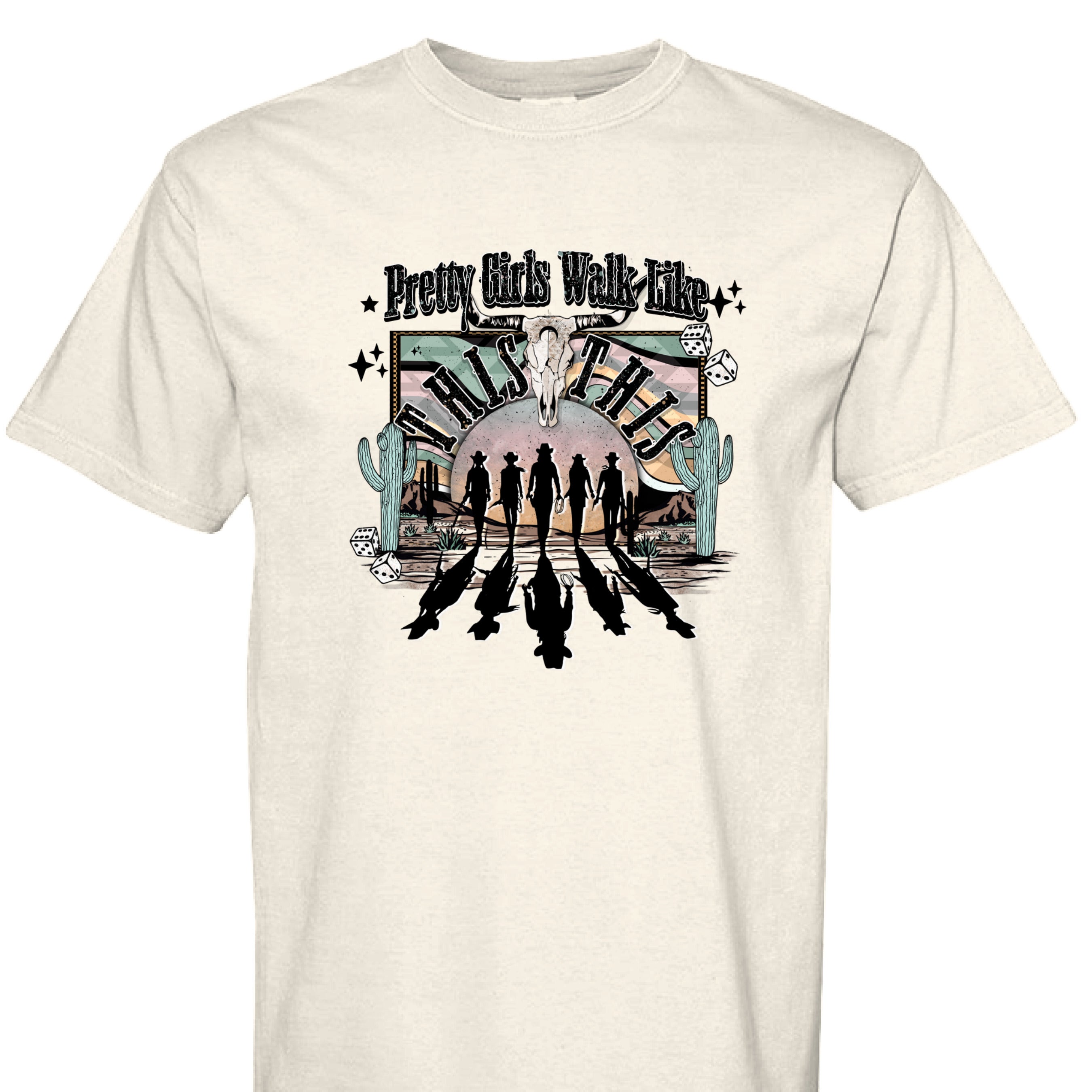 IVORY - FRONT - Western graphic T-shirt design with cowgirl silhouettes, steer skull, desert sunset, dice, and text Pretty Girls Walk Like This.