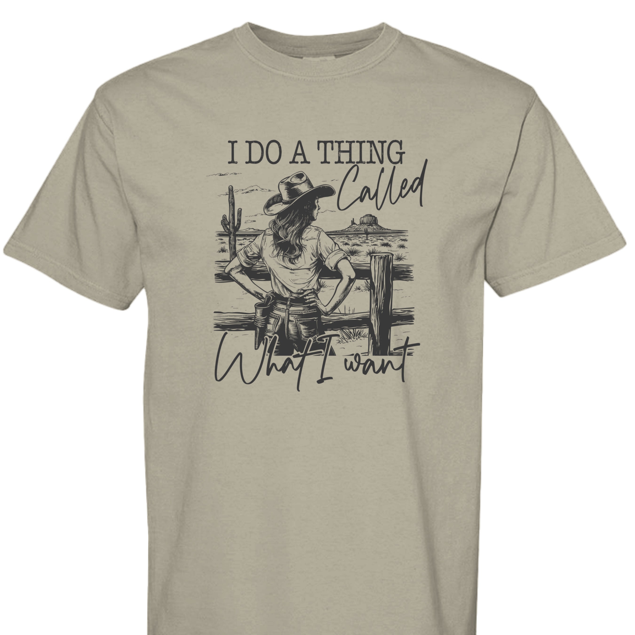 SANDSTONE - FRONT - I Do a Thing Called What I Want western shirt with cowgirl in hat and boots leaning on fence in desert landscape.