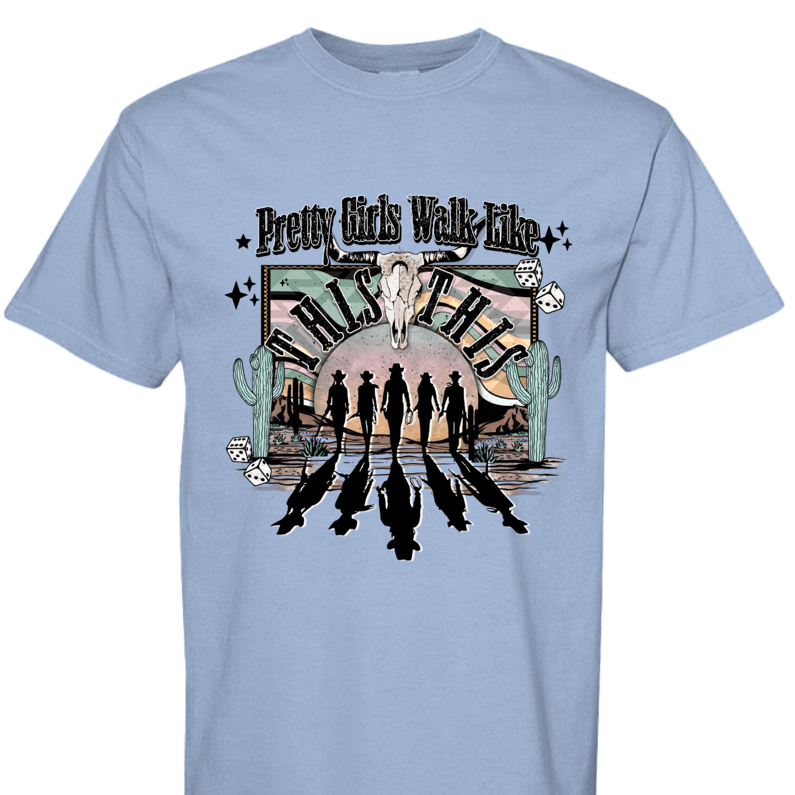 WASHED DENIM - FRONT - Western graphic T-shirt design with cowgirl silhouettes, steer skull, desert sunset, dice, and text Pretty Girls Walk Like This.
