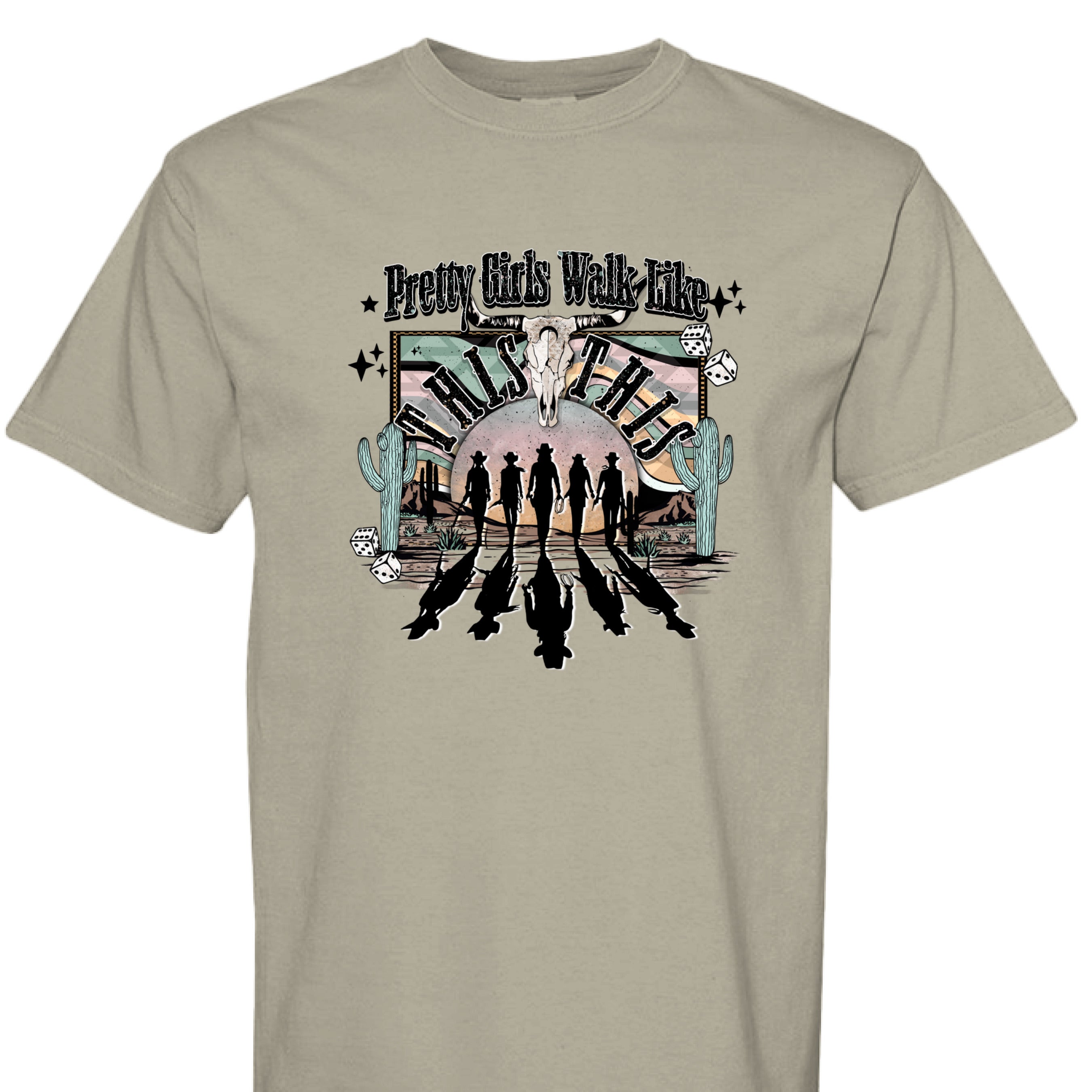 SANDSTONE - FRONT - Western graphic T-shirt design with cowgirl silhouettes, steer skull, desert sunset, dice, and text Pretty Girls Walk Like This.
