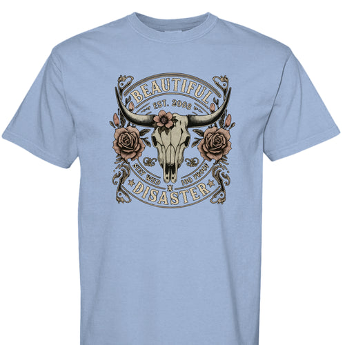 WASHED DENIM - FRONT - Western graphic t-shirt featuring a longhorn skull with roses and text ‘Beautiful Disaster – Stay Wild 100 Proof.’ Vintage distressed design.